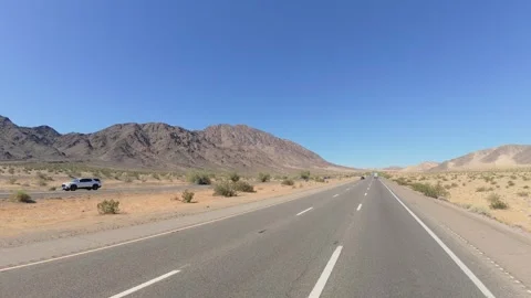 First person view driving forward on arid desert highway on a hot summer day Vídeos de archivo 334625483