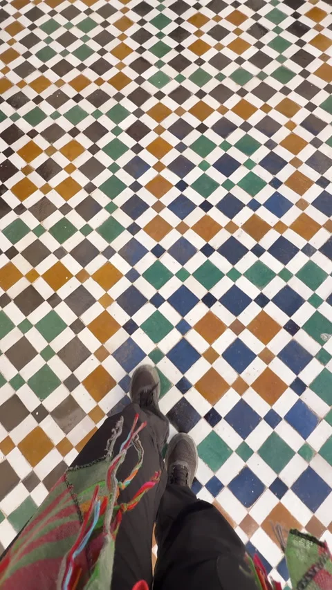 First-person view of feet walking on a colorful Zellij mosaic floor in Morocco Stock Footage 339498841