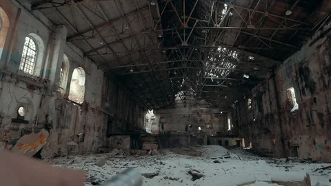 First person view with flashlight in large empty ruined and abandoned industrial Stock Footage 100983089