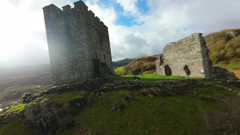 First person view flying around ancient castle ruins in wales Stock Footage 327065980
