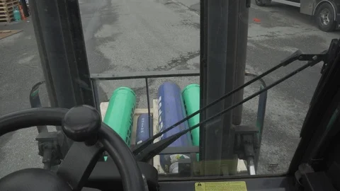 First person view of forklift driver driving a forklift loaded with gas tanks. Stock Footage 90532135