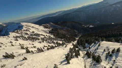 First Person View (FPV) Drone Diving Down a Steep Snowy Mountain Slope Stock Footage 321149647