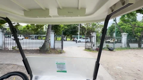 First Person View of Golf Cart Navigating Manila Park and Intersection Stock Footage 334827707