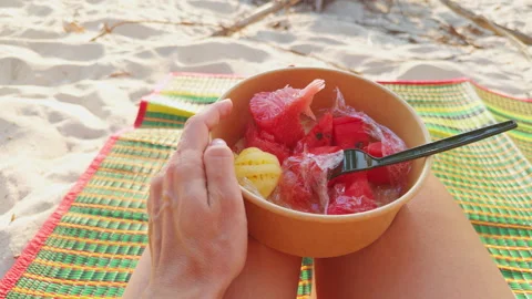 First Person View Of Hand Picking Mini Pineapple Piece From Bowl Of Mixed Fruit Stock Footage 332300168