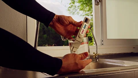 First Person View Of Hands Testing Drinking Water With Digital Quality Meter Sho Stock Footage 330638748