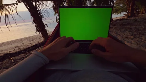 First Person View Of Hands Typing On Laptop With Green Screen While Lying In Ham Stock Footage 326973429