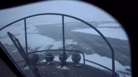 First-person view in Hivus hovercraft racing frozen Lake Baikal during blizzard  Stock Footage 316108131