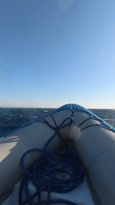 First person view from an inflatable boat navigating through choppy waters on a Stock Footage 335150468