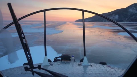 First person view from inside ice boat hovercraft ride winter lake Baikal sunset Video stock 165217426