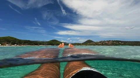 First person view of legs floating on seawater at Santa Giulia Vídeo Stock 278943561