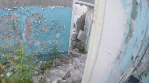 First-person view. man inspects corridors of destroyed building Video stock 68517739