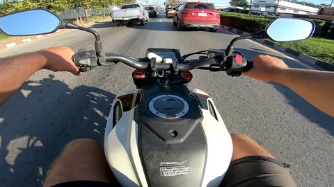 First-person view - a man on a motorcycle rides among cars Stock Footage 169916626