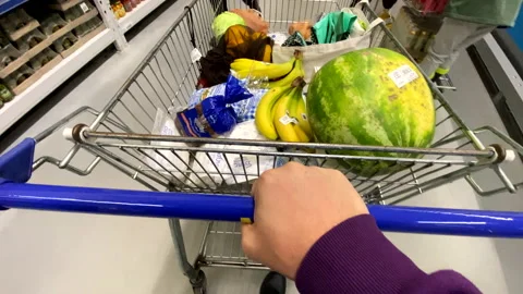 First person view man pushing trolley and taking goods from the shelf Stock Footage 211811402
