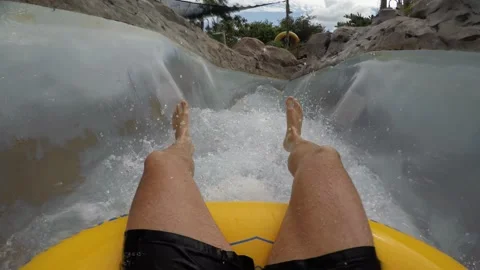 First Person View of Man Riding in a Waterslide while water is Splashing Vídeo Stock 135834697