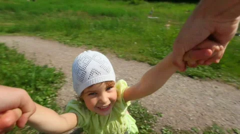 First person view from man rotates his little daughter in park Stock Footage 598646