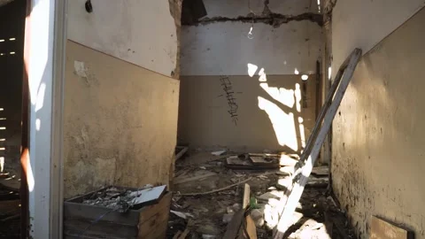First-person view of a man walking among rubble in an abandoned building Stock Footage 272726042