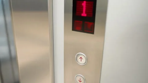 First-Person View of a Modern Elevator Panel with Button Press Stock Footage 281673767
