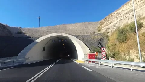 First-person view of a moving car on a highway, ride inside the tunnel. 動画素材 321093806
