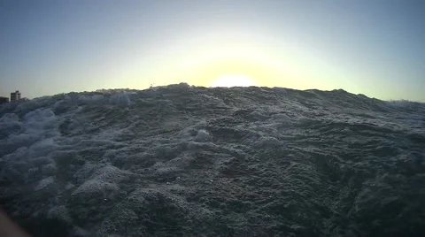 First person view of the ocean looking to the city on the shore Stock Footage 54263489