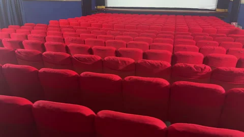 First-Person View of an Old, Empty Cinema with Rows of Red Seats Stock Footage 304284818