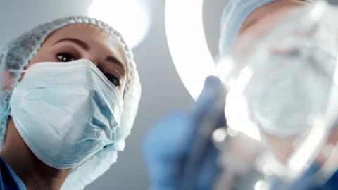 First-person view of the oxygen mask in doctor's hand. Patient looking to the Stock Footage 141290616