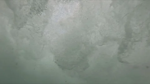 First person view of a person sinking underwater with air bubbles rising ar.. Video stock 318061980