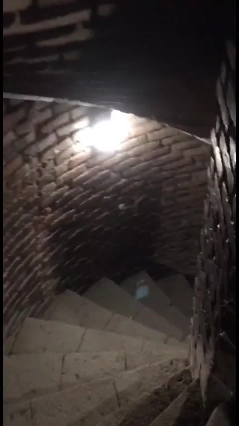 First-person view of a person using a phone light to navigate down a dark, Stock-Footage 333376797