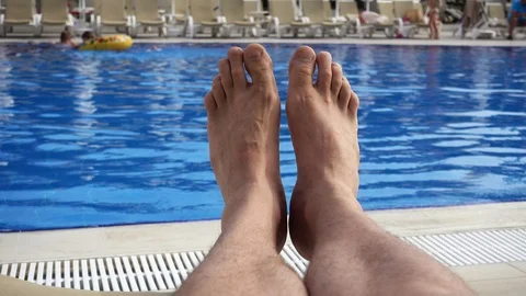 A first person view, a point of looking at a man who is resting by the pool.  Видео 91718910