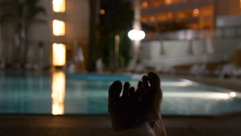 A first person view, a point of looking at a man who is resting by the pool at n Видео 97099057