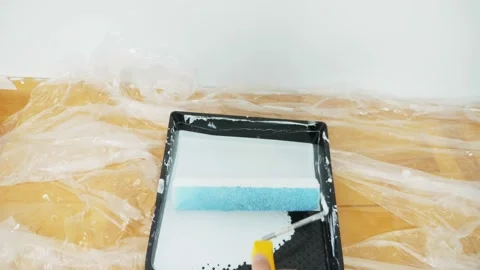 First-person view point male hand with roller paints the wall. Stock Footage 144433587