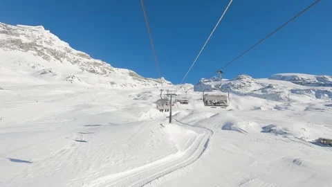First person view pov of riding chair lift in italian ski resort, background Stock Footage 290943379