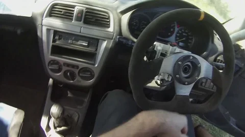 First Person View of rally driver climbing into subaru race car at the track Video stock 74398618