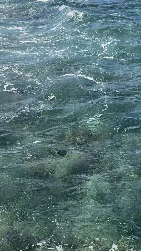 First person view of relaxing legs over turquoise sea water 스톡 동영상 331120274
