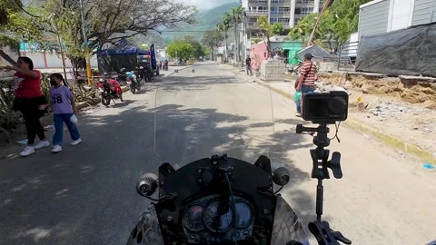 First-person view riding a motorcycle through a devastated urban street in La 動画素材 341750060
