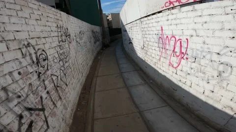 First person view running through a very narrow passage in the morning in 4k Stockbeeldmateriaal 150315125