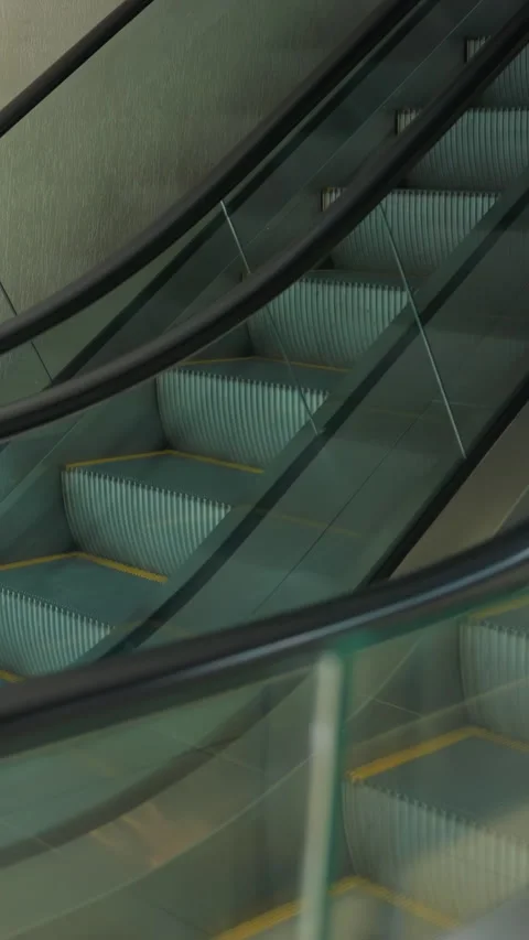First-Person View of Side-by-Side Escalators in a Modern Indoor Setting Stock Footage 316502186