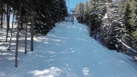 First-person view of the ski elevator on a sunny day Stock Footage 219004844
