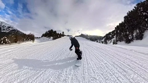 First person view of snowboarding down a mountain slope Stock Footage 340789688
