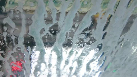 First person view of soap foam spraying on car windshield Stock Footage 339240362