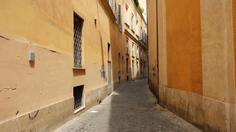 First person view of someone walk along deserted alley in Rome. Tourist going Stock Footage 104980032
