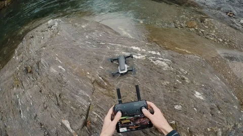 First-person view, taking off drone with remote control in the hands of a man Stock Footage 119795334