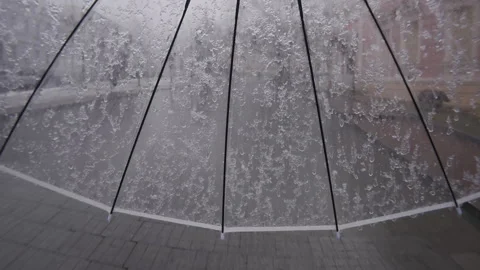 First person view, time lapse of wet spring snow falling on transparent umbrella Stock Footage 329124404