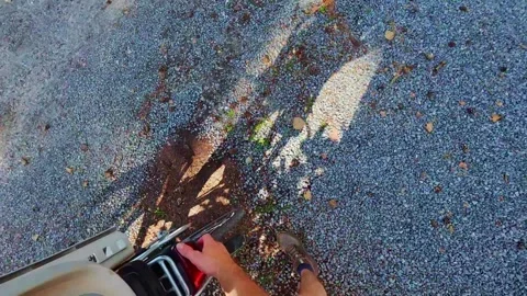 First person view of unlocking the battery of the bicycle to check if it's Stock Footage 340353593