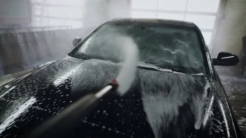 First-person view. Unrecognizable man washing a car using a powerful sprayer Stock Footage 171870724