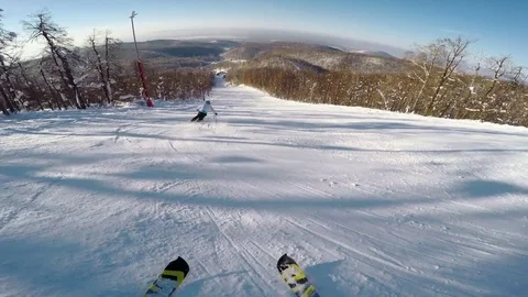 First person view: Unrecognizable skier riding down the mountain slope, having Stock Footage 72602441