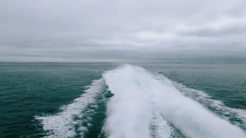 First person view of a wake trail from ship. White foam trace from a cruise boat Stock Footage 278829714