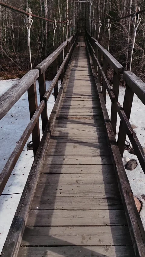 First person view walking across wooden suspension bridge. vertical. Stock Footage 340688987