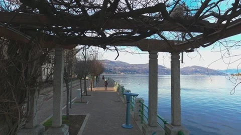 First person view walking along Arona waterfront of Lake Maggiore 動画素材 279892450