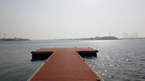 First-person view walking along the pier on Palm Jumeirah, Dubai, with water, Stock Footage 312335252