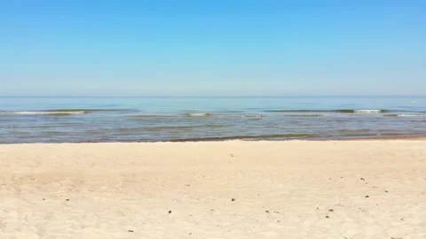First person view walking on the beach towards calm baltic sea in relaxing su Stock Footage 155790063